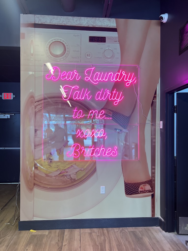Hot pink neon sign reading Dear Laundry, talk dirty to me, xoxo Britches